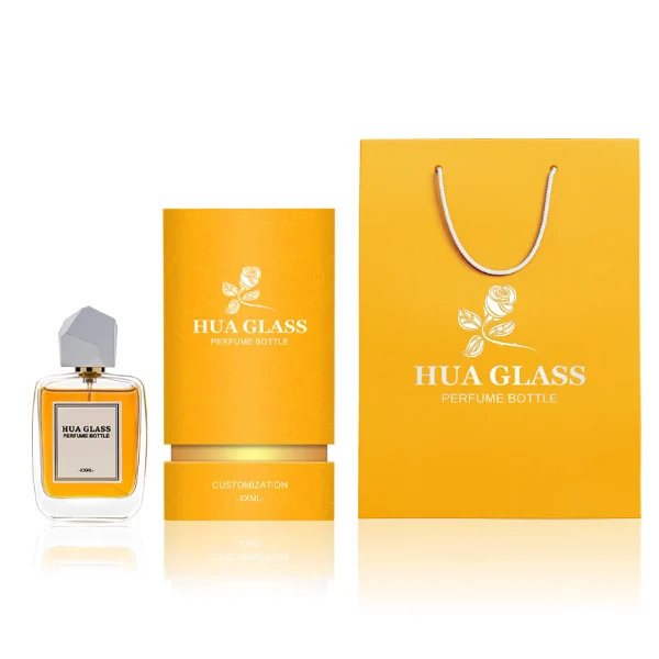 HUA0218 perfume bottle, rounded square transparent glass body with thick base, 30 ml, 50 ml, or 100 ml liquid, geometric multi-faceted plastic cap in black or white, brand label applied on bottle, modern luxurious fashion design, ideal for gifting and daily use.