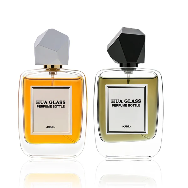 HUA0218 perfume bottle, rounded square transparent glass body with thick base, 30 ml, 50 ml, or 100 ml liquid, geometric multi-faceted plastic cap in black or white, brand label applied on bottle, modern luxurious fashion design, ideal for gifting and daily use.