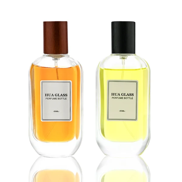 HUA0219 perfume bottle, rounded rectangular transparent glass body with thick base, 50 ml or 100 ml liquid, cylindrical wooden cap in black or natural wood color, brand label applied on bottle, modern elegant fashion design, ideal for gifting and daily use.
