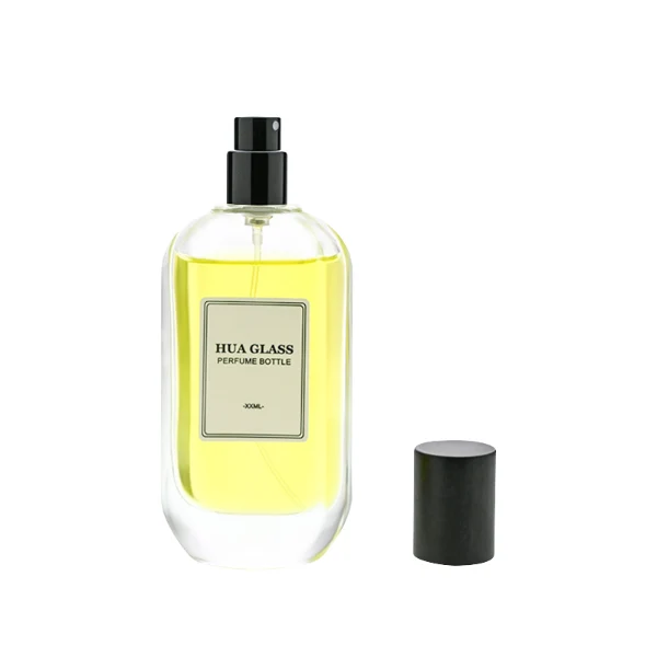 HUA0219 perfume bottle, rounded rectangular transparent glass body with thick base, 50 ml or 100 ml liquid, cylindrical wooden cap in black or natural wood color, brand label applied on bottle, modern elegant fashion design, ideal for gifting and daily use.