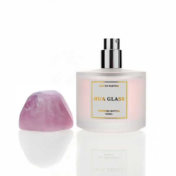HUA0225 perfume bottle, rounded frosted glass body with thick base, 30 ml, 50 ml, or 100 ml liquid, irregular-shaped resin cap with customizable colors, brand label applied on bottle, modern luxurious fashion design, ideal for gifting and daily use.