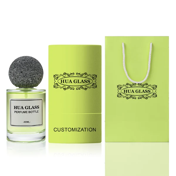 HUA0228 perfume bottle, cylindrical transparent glass body with thick base, 30 ml, 50 ml, or 100 ml liquid, spherical artificial stone cap with natural texture, brand label applied on bottle, modern luxurious fashion design, ideal for gifting and daily use.