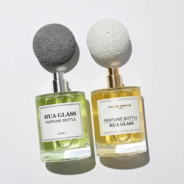 HUA0228 perfume bottle, cylindrical transparent glass body with thick base, 30 ml, 50 ml, or 100 ml liquid, spherical artificial stone cap with natural texture, brand label applied on bottle, modern luxurious fashion design, ideal for gifting and daily use.
