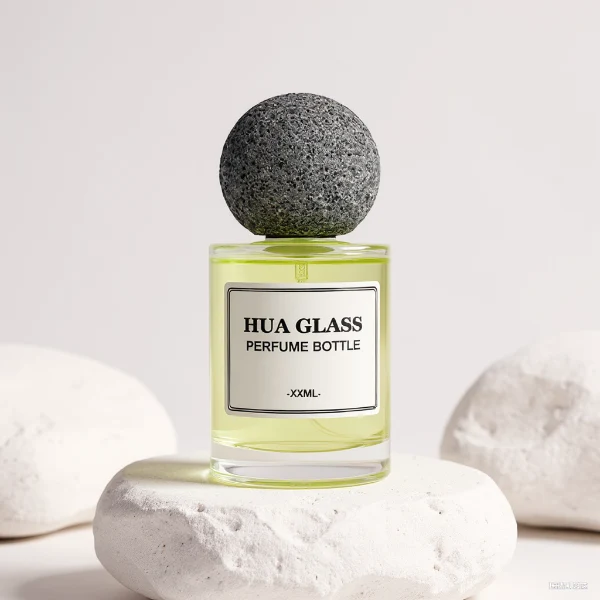 HUA0228 perfume bottle, cylindrical transparent glass body with thick base, 30 ml, 50 ml, or 100 ml liquid, spherical artificial stone cap with natural texture, brand label applied on bottle, modern luxurious fashion design, ideal for gifting and daily use.