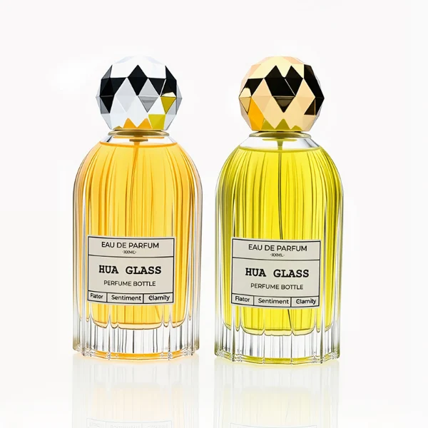 HUA0229 perfume bottle, cylindrical transparent glass body with ribbed sides and thick base, 100 ml liquid, faceted geometric sphere plastic cap in gold or silver, brand label applied on bottle, modern luxurious fashion design, ideal for gifting and daily use.