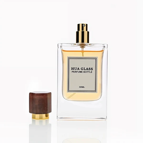 HUA0231 perfume bottle, rectangular transparent glass body with thick base, 30 ml, 50 ml, or 100 ml liquid, irregular natural stone cap with gold neck, brand label applied on bottle, modern luxurious fashion design, ideal for gifting and daily use.