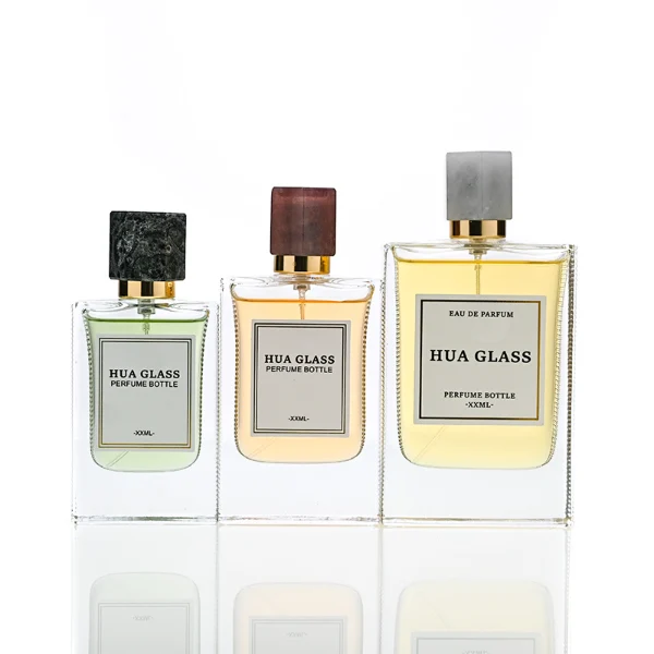 HUA0231 perfume bottle, rectangular transparent glass body with thick base, 30 ml, 50 ml, or 100 ml liquid, irregular natural stone cap with gold neck, brand label applied on bottle, modern luxurious fashion design, ideal for gifting and daily use.