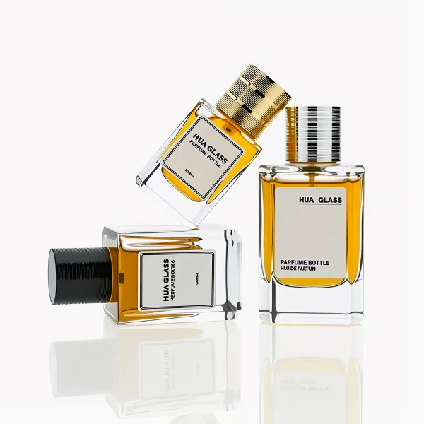 HUA0235 perfume bottle, square transparent glass body with thick base, 30 ml, 50 ml, or 100 ml liquid, cylindrical plastic cap with side threading and metallic finish in gold, black, or silver, brand label applied on bottle, modern luxurious design, ideal for gifting and daily use.