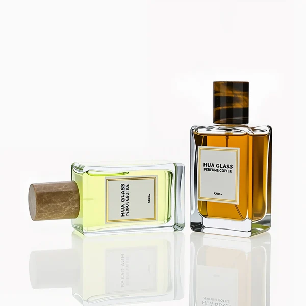 HUA0236 perfume bottle, square transparent glass body with thick base, 100 ml liquid, cylindrical natural stone cap, brand label applied on bottle, modern luxurious design, ideal for gifting and daily use.