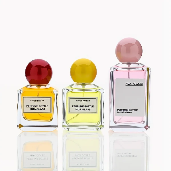 HUA0237 perfume bottle, square transparent glass body with thick base, 50 ml, 70 ml, or 100 ml liquid, spherical plastic cap, customizable, brand label applied on bottle, modern luxurious design, ideal for gifting and daily use.