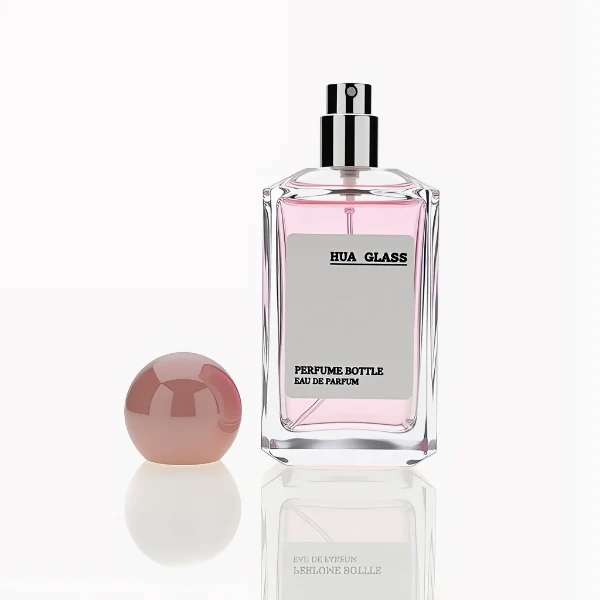 HUA0237 perfume bottle, square transparent glass body with thick base, 50 ml, 70 ml, or 100 ml liquid, spherical plastic cap, customizable, brand label applied on bottle, modern luxurious design, ideal for gifting and daily use.