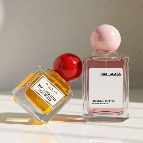 HUA0237 perfume bottle, square transparent glass body with thick base, 50 ml, 70 ml, or 100 ml liquid, spherical plastic cap, customizable, brand label applied on bottle, modern luxurious design, ideal for gifting and daily use.