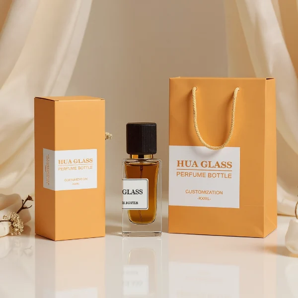 HUA0240 perfume bottle, square transparent glass body with thick base, 30 ml, 50 ml, or 100 ml liquid, square wooden cap with gold neck, brand label applied on bottle, modern luxurious design, ideal for gifting and daily use.