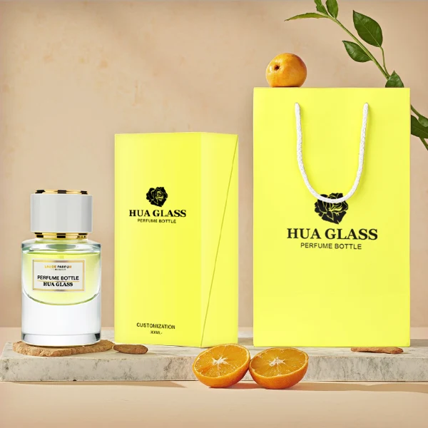 HUA0242 perfume bottle, cylindrical transparent glass body with thick base, 30 ml, 50 ml, or 100 ml liquid, cylindrical plastic cap with black or white side and silver plastic rings on both top and bottom, brand label applied on bottle, modern luxurious design, ideal for gifting and daily use.