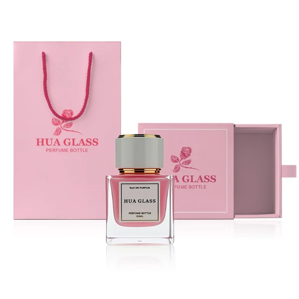 HUA0243 perfume bottle, cylindrical transparent internal spray glass body with thick base, 30 ml, 50 ml, or 100 ml liquid, cylindrical plastic cap with black or white side and gold or silver plastic rings on both top and bottom, brand label applied on bottle, modern luxurious design, ideal for gifting and daily use.