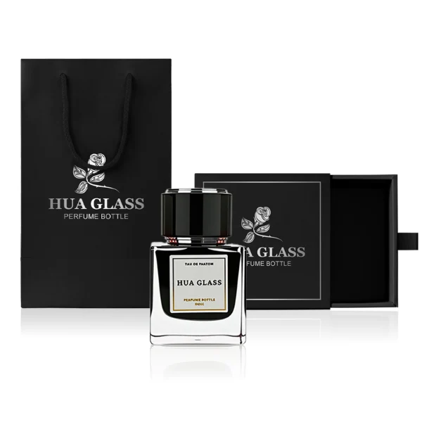 HUA0243 perfume bottle, cylindrical transparent internal spray glass body with thick base, 30 ml, 50 ml, or 100 ml liquid, cylindrical plastic cap with black or white side and gold or silver plastic rings on both top and bottom, brand label applied on bottle, modern luxurious design, ideal for gifting and daily use.