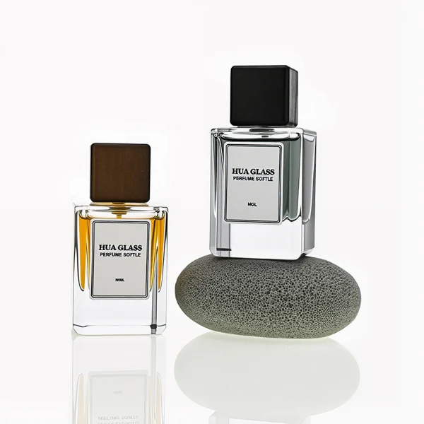 HUA0246 perfume bottle, rectangular transparent glass body with thick base, 30 ml, 50 ml, or 100 ml liquid, rectangular wooden cap, brand label applied on bottle, modern luxurious design, ideal for gifting and daily use.