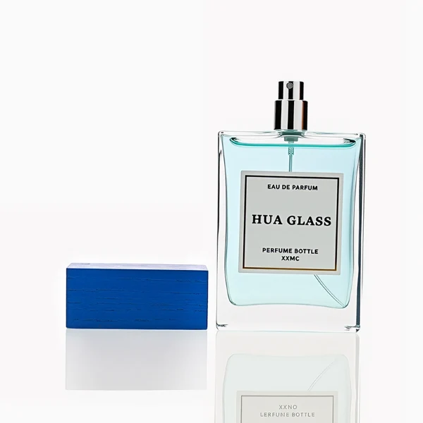 HUA0247 perfume bottle, rectangular transparent glass body with thick base, 100 ml liquid, rectangular wooden cap with customizable color, brand label applied on bottle, modern luxurious design, ideal for gifting and daily use.