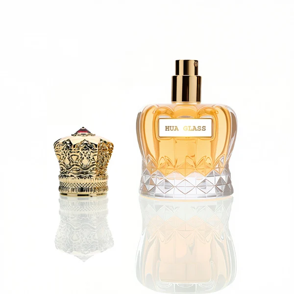 HUA0249 perfume bottle, faceted transparent glass body with thick base, 30 ml, 50 ml, or 100 ml liquid, ornate crown-shaped Zamac cap, brand label applied on bottle, luxurious ornate design, ideal for gifting and daily use.