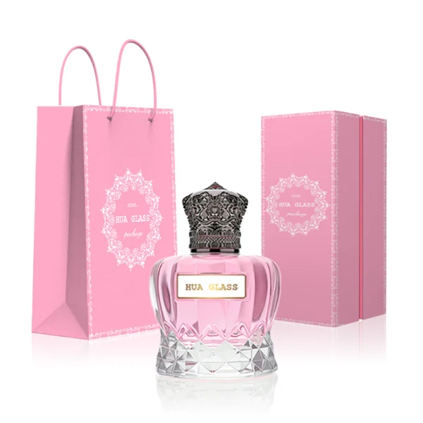 HUA0249 perfume bottle, faceted transparent glass body with thick base, 30 ml, 50 ml, or 100 ml liquid, ornate crown-shaped Zamac cap, brand label applied on bottle, luxurious ornate design, ideal for gifting and daily use.