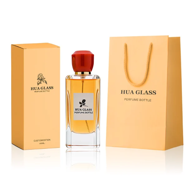 HUA0252 perfume bottle, rectangular transparent glass body with rounded edges and thick base, 50 ml or 80 ml liquid, yellow or red faceted geometric resin cap with smooth glossy finish, gold-colored bottle neck, brand label applied on bottle, modern artistic luxury design, ideal for gifting and daily use.