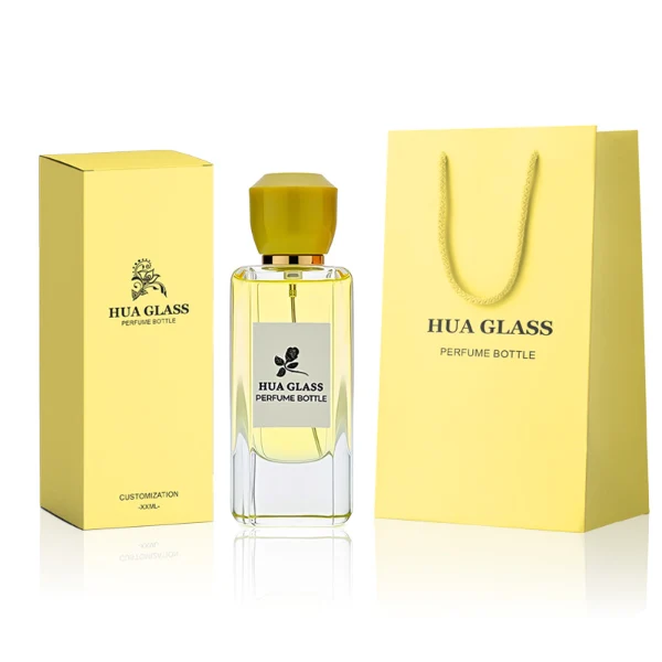HUA0252 perfume bottle, rectangular transparent glass body with rounded edges and thick base, 50 ml or 80 ml liquid, yellow or red faceted geometric resin cap with smooth glossy finish, gold-colored bottle neck, brand label applied on bottle, modern artistic luxury design, ideal for gifting and daily use.