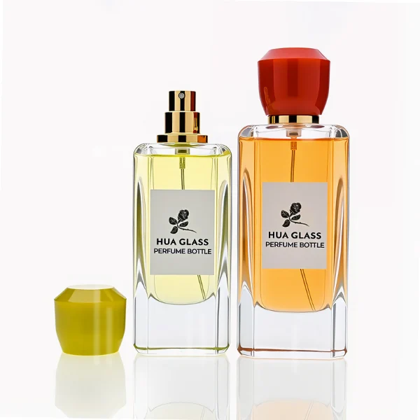 HUA0252 perfume bottle, rectangular transparent glass body with rounded edges and thick base, 50 ml or 80 ml liquid, yellow or red faceted geometric resin cap with smooth glossy finish, gold-colored bottle neck, brand label applied on bottle, modern artistic luxury design, ideal for gifting and daily use.