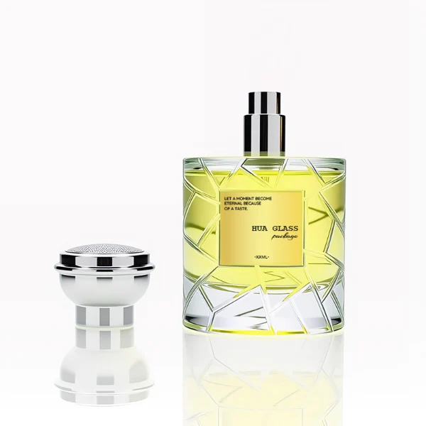 HUA0253 perfume bottle, faceted transparent glass body with geometric cut texture and thick base, 100 ml liquid, layered flat cylindrical cap with flat top, narrowed middle section and mirror metallic finish in gold or silver color matching the bottle neck, aluminum label/sticker applied on bottle, modern luxury design, ideal for gifting and daily use.