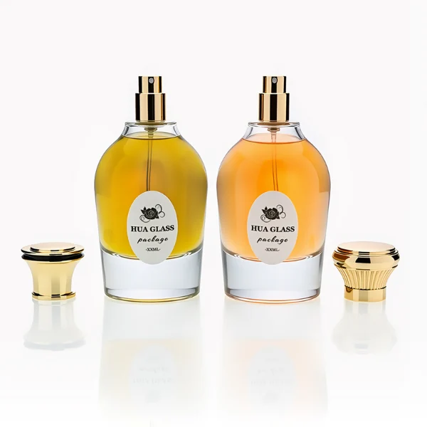 HUA0254 perfume bottle, rounded transparent glass body with smooth curved silhouette and thick base, 100 ml liquid, flared cylindrical Zamac cap with glossy finish, available in ribbed side texture or smooth side surface style, printed logo on bottle, elegant modern luxury design, ideal for gifting and daily use.