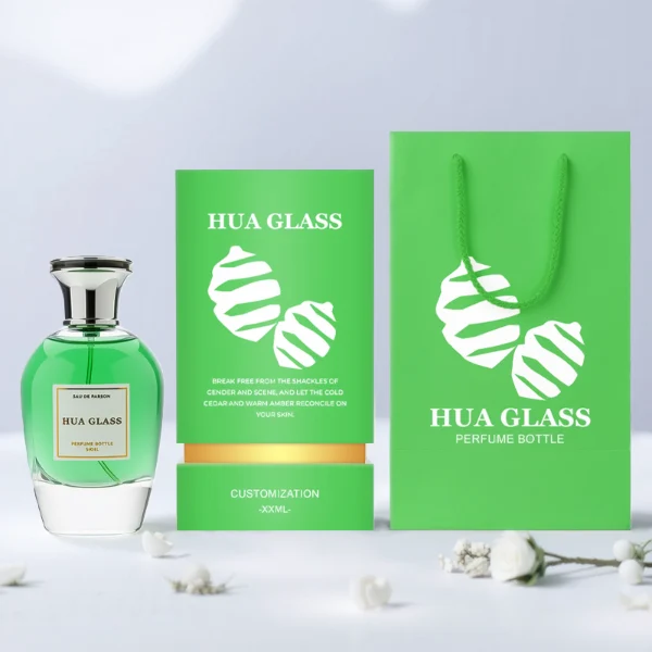 HUA0255 perfume bottle, rounded transparent glass body with soft curved silhouette and thick base, 100 ml liquid, flared Zamac cap with flat top and glossy finish, printed logo label, elegant luxury design, ideal for gifting and daily use.