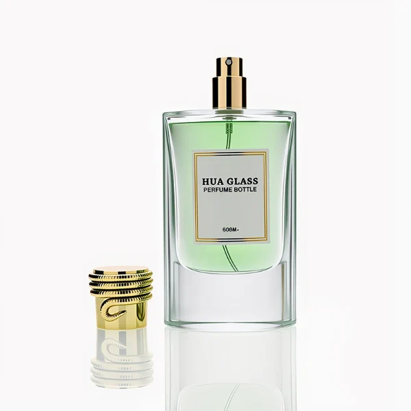 HUA0256 perfume bottle, transparent glass body with rectangular paper bag-inspired silhouette, smooth curved shoulders and oval thick base, 80 ml liquid, cylindrical plastic cap with layered ring texture and metallic glossy finish, printed logo label, modern luxury design, ideal for gifting and daily use.