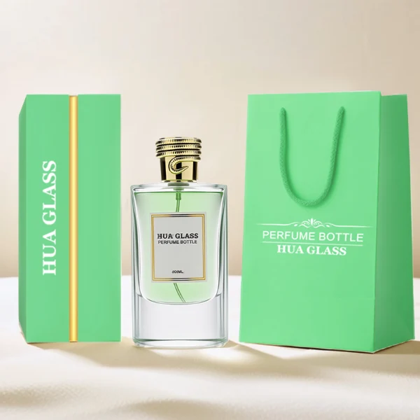 HUA0256 perfume bottle, transparent glass body with rectangular paper bag-inspired silhouette, smooth curved shoulders and oval thick base, 80 ml liquid, cylindrical plastic cap with layered ring texture and metallic glossy finish, printed logo label, modern luxury design, ideal for gifting and daily use.