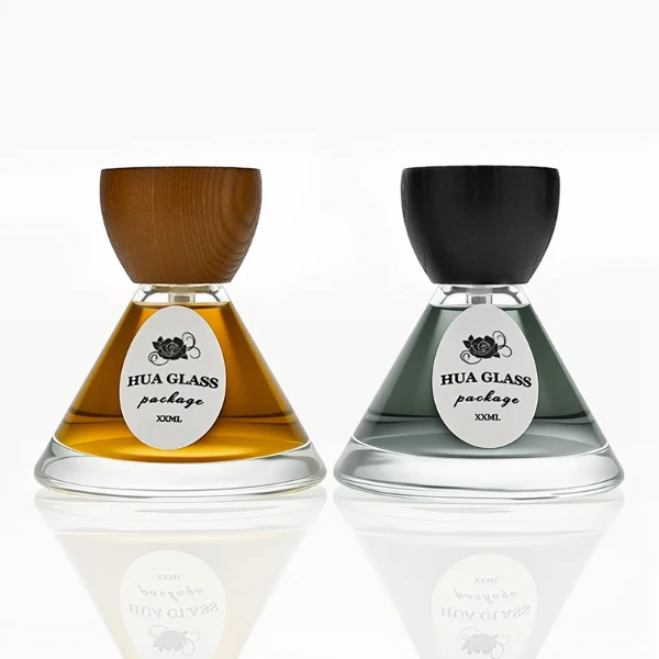 HUA0257 perfume bottle, transparent glass body with wide cone-shaped silhouette and thick rounded base, 30 ml, 50 ml, or 100 ml liquid, rounded wooden cap with matte finish and bowl-shaped silhouette in black or brown color, printed logo label, artistic modern luxury design, ideal for gifting and daily use.