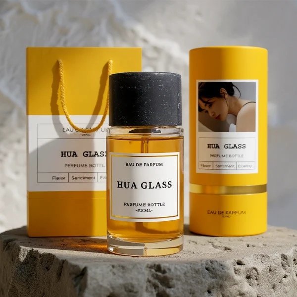 HUA0262 perfume bottle, cylindrical transparent glass body with thick rounded base, 30 ml, 50 ml, or 100 ml liquid, oversized flat cylindrical artificial stone cap with matte texture, printed logo label, modern minimalist luxury design, ideal for gifting and daily use.