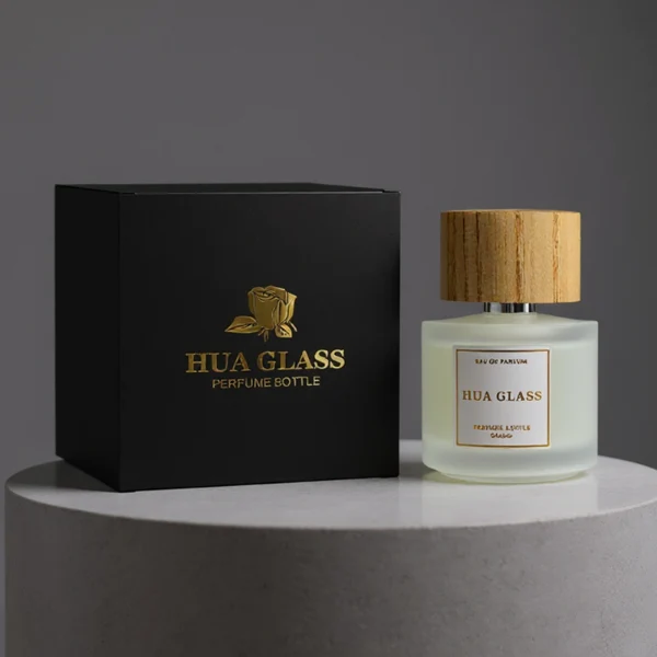 HUA0263 perfume bottle, frosted cylindrical glass body with thick rounded base, 30 ml, 50 ml, or 100 ml liquid, flat cylindrical bamboo cap with natural wood grain texture and silver bottle neck, printed logo label, natural minimalist luxury design, ideal for gifting and daily use.