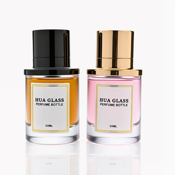 HUA0264 perfume bottle, cylindrical transparent glass body with thick rounded base, 50 ml or 100 ml liquid, stamp-shaped aluminum and magnet cap with glossy black or gold finish, printed logo label, modern luxury minimalist design, ideal for gifting and daily use.
