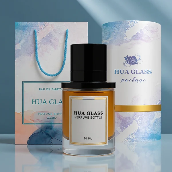 HUA0264 perfume bottle, cylindrical transparent glass body with thick rounded base, 50 ml or 100 ml liquid, stamp-shaped aluminum and magnet cap with glossy black or gold finish, printed logo label, modern luxury minimalist design, ideal for gifting and daily use.
