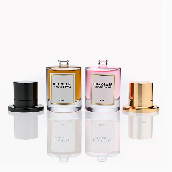 HUA0264 perfume bottle, cylindrical transparent glass body with thick rounded base, 50 ml or 100 ml liquid, stamp-shaped aluminum and magnet cap with glossy black or gold finish, printed logo label, modern luxury minimalist design, ideal for gifting and daily use.