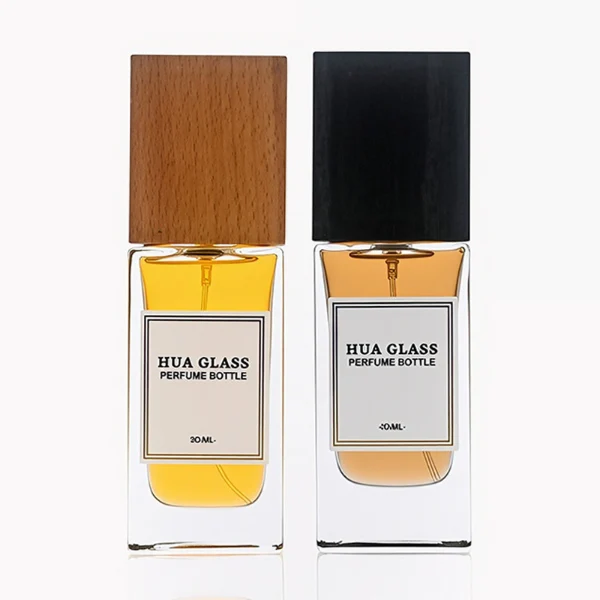 HUA0265 perfume bottle, rectangular transparent glass body with thick weighted base and rounded vertical edges, 30 ml, 50 ml, or 100 ml liquid, oversized rectangular plastic cap in wood-grain brown or matte black finish, printed logo label, modern minimalist luxury design, ideal for gifting and daily use.