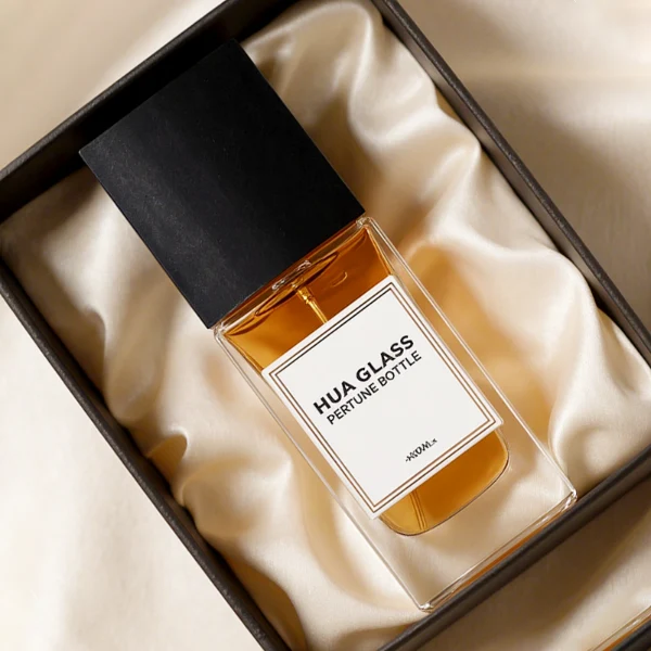 HUA0265 perfume bottle, rectangular transparent glass body with thick weighted base and rounded vertical edges, 30 ml, 50 ml, or 100 ml liquid, oversized rectangular plastic cap in wood-grain brown or matte black finish, printed logo label, modern minimalist luxury design, ideal for gifting and daily use.