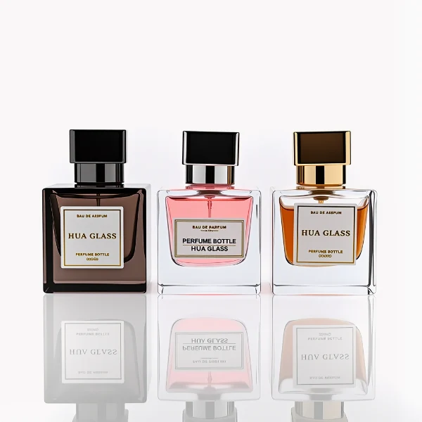 HUA0266 perfume bottle, square glass body with faceted angular corners and thick weighted base, available in transparent colorless glass or semi-transparent black glass, 30 ml, 50 ml, or 100 ml liquid, geometric rectangular Zamac cap with glossy metallic finish in silver, gold, or black color, printed logo label, modern luxury fashion design, ideal for gifting and daily use.