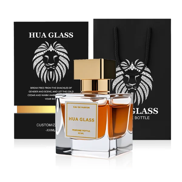 HUA0266 perfume bottle, square glass body with faceted angular corners and thick weighted base, available in transparent colorless glass or semi-transparent black glass, 30 ml, 50 ml, or 100 ml liquid, geometric rectangular Zamac cap with glossy metallic finish in silver, gold, or black color, printed logo label, modern luxury fashion design, ideal for gifting and daily use.