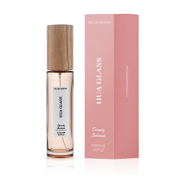 HUA0269 perfume bottle, slim cylindrical transparent glass body with rounded base, 30 ml, 50 ml, or 100 ml liquid, tall cylindrical wooden cap with natural wood grain texture, printed vertical logo label, natural minimalist elegance design, ideal for gifting and travel use.