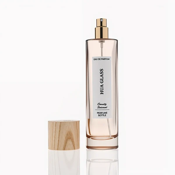 HUA0269 perfume bottle, slim cylindrical transparent glass body with rounded base, 30 ml, 50 ml, or 100 ml liquid, tall cylindrical wooden cap with natural wood grain texture, printed vertical logo label, natural minimalist elegance design, ideal for gifting and travel use.