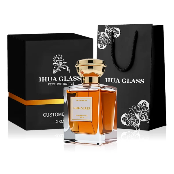 HUA0273 perfume bottle, transparent rectangular glass body with beveled edges and thick base, 50 ml or 100 ml liquid, glossy bowl-shaped plastic cap in silver or gold with matching bottle neck, brand label attached on bottle surface, modern elegant luxury design, ideal for gifting and daily use.