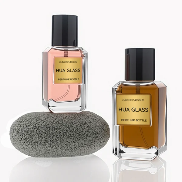 HUA0275 perfume bottle, transparent colorless octagonal glass body with beveled edges and thick base, 30 ml or 50 ml liquid, glossy black cylindrical plastic cap with flat top, aluminum label/sticker attached on bottle surface, modern minimalist luxury design, ideal for gifting and daily use.