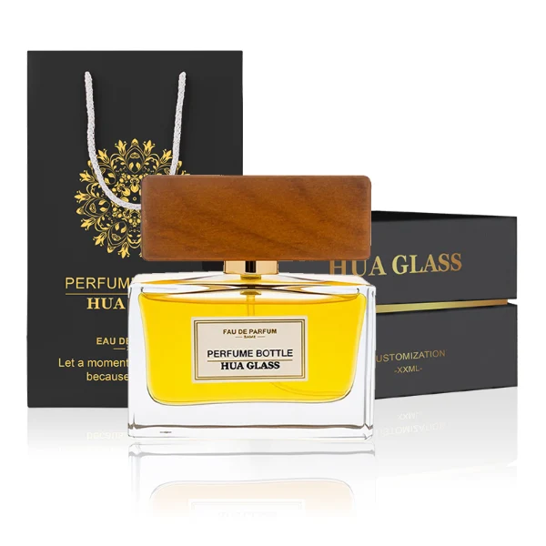 HUA0277 perfume bottle, transparent colorless rectangular glass body with thick base and straight edges, 30 ml, 50 ml, or 100 ml liquid, wide flat rectangular wooden cap in black or natural wood finish with gold bottle neck, printed label attached on bottle surface, modern minimalist luxury design, ideal for gifting and daily use.