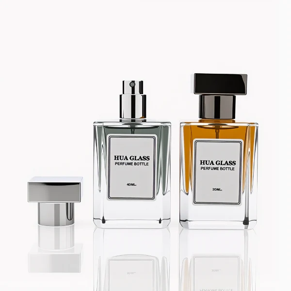 HUA0278 perfume bottle, transparent colorless rectangular glass body with angular edges and thick base, 30 ml, 50 ml, or 100 ml liquid, glossy black or silver square Zamac cap with matching bottle neck, printed label attached on bottle surface, modern masculine luxury design, ideal for gifting and daily use.