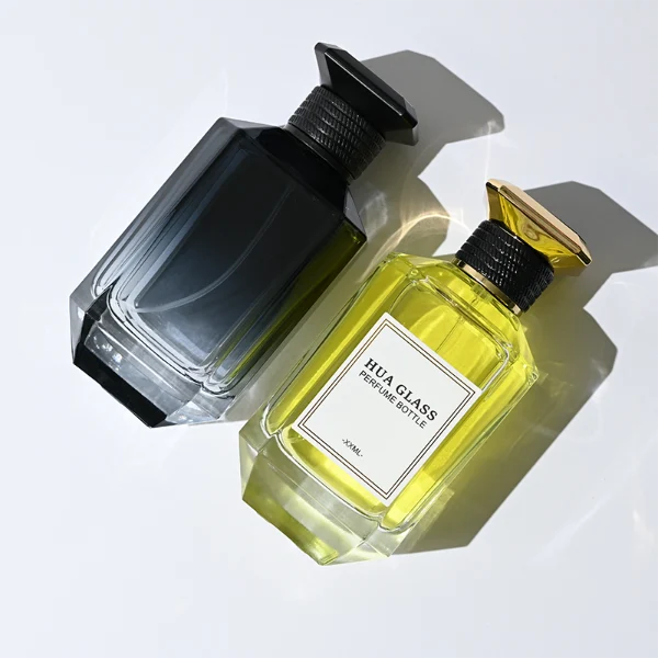 HUA0279 perfume bottle, transparent or customizable gradient geometric glass body with thick base and beveled edges, 30 ml, 50 ml, or 100 ml liquid, flat diamond-top threaded plastic cap in black or gold finish, printed logo label attached on bottle surface, modern luxury fashion design, ideal for gifting and daily use.