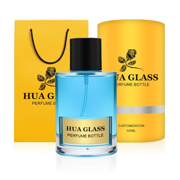 HUA0280 perfume bottle, cylindrical transparent glass body with thick base, 100 ml liquid, glossy flat cylindrical plastic cap in black or white, aluminum label/sticker attached on bottle surface, modern minimalist fashion design, ideal for gifting and daily use.